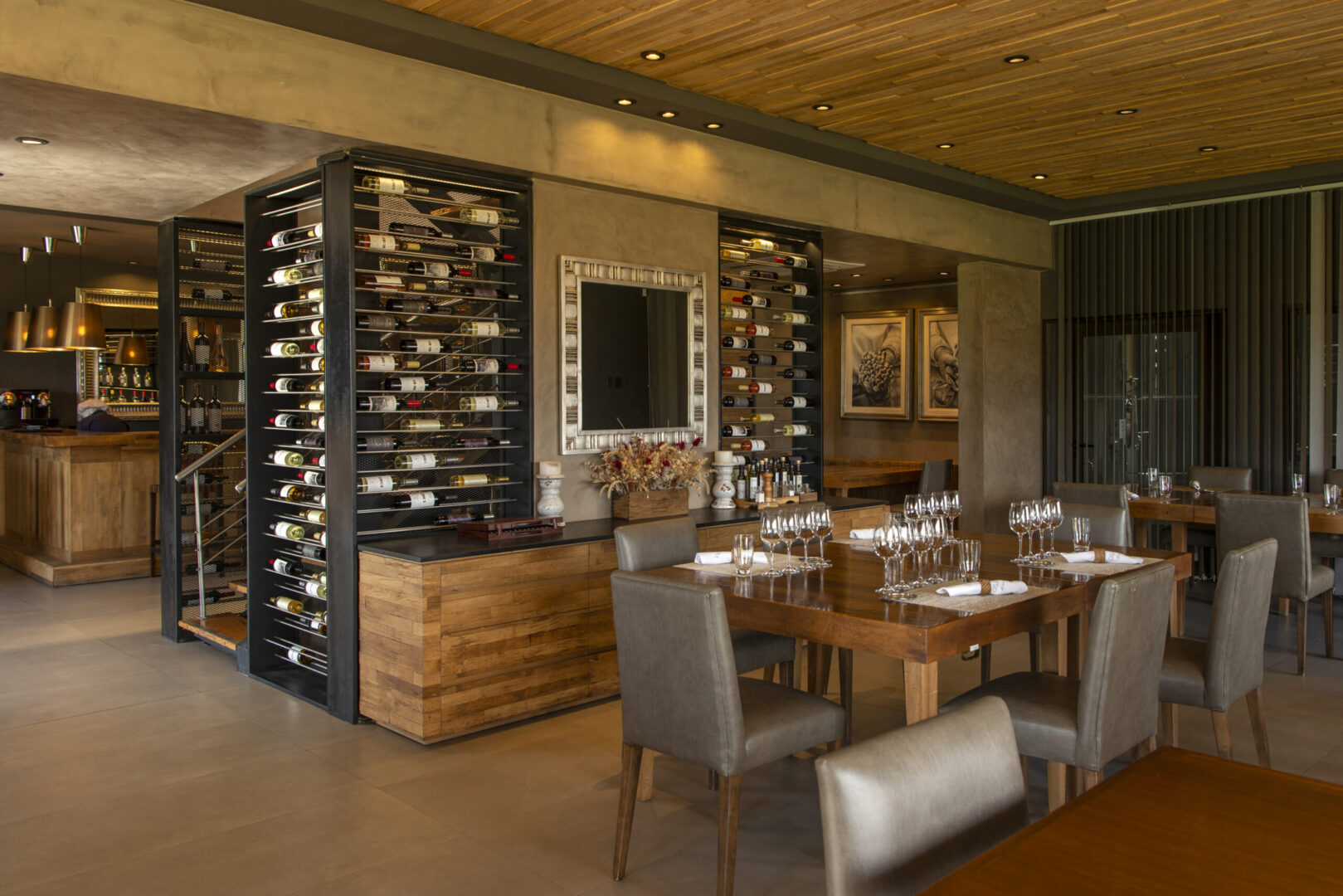 A restaurant with a lot of wine racks and tables